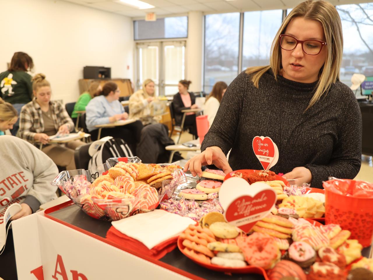 A student selects a treat from the Buckeye Love cart