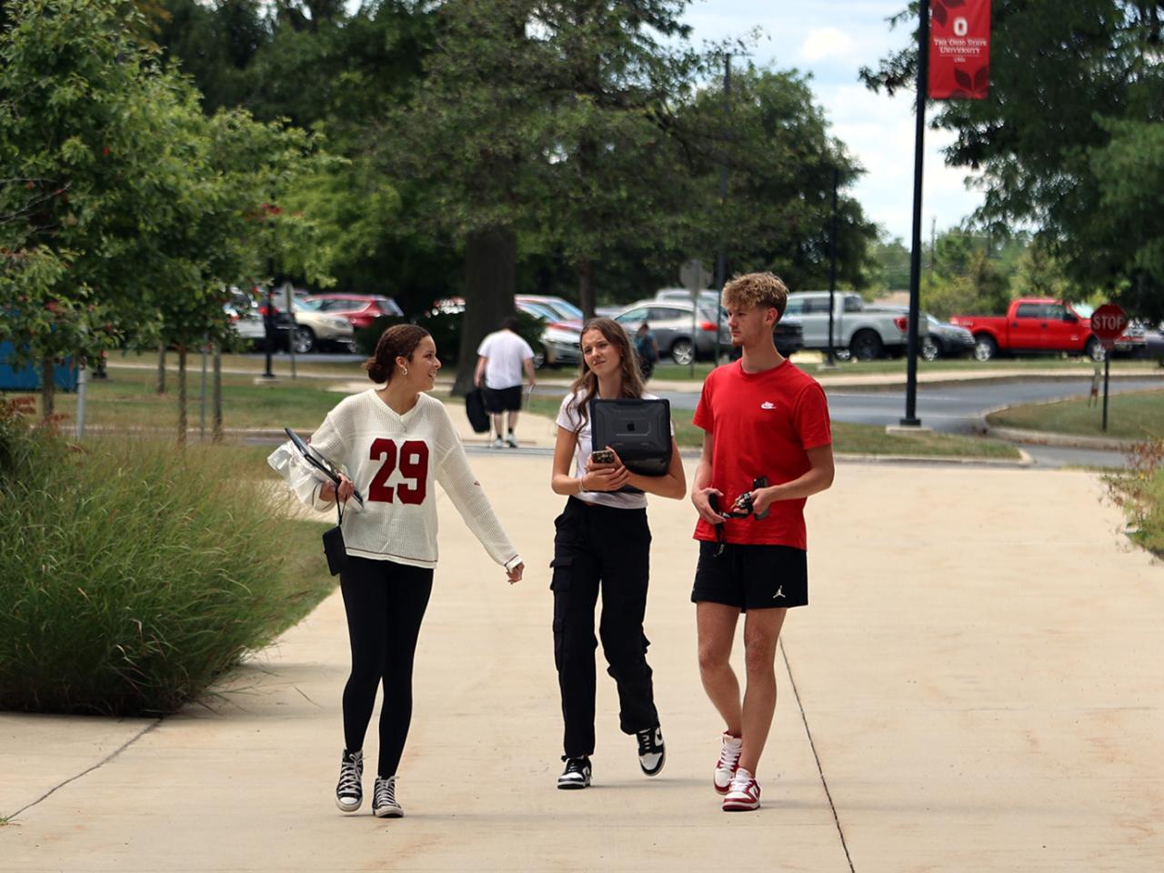Three students walk onto the Ohio State Lima campus