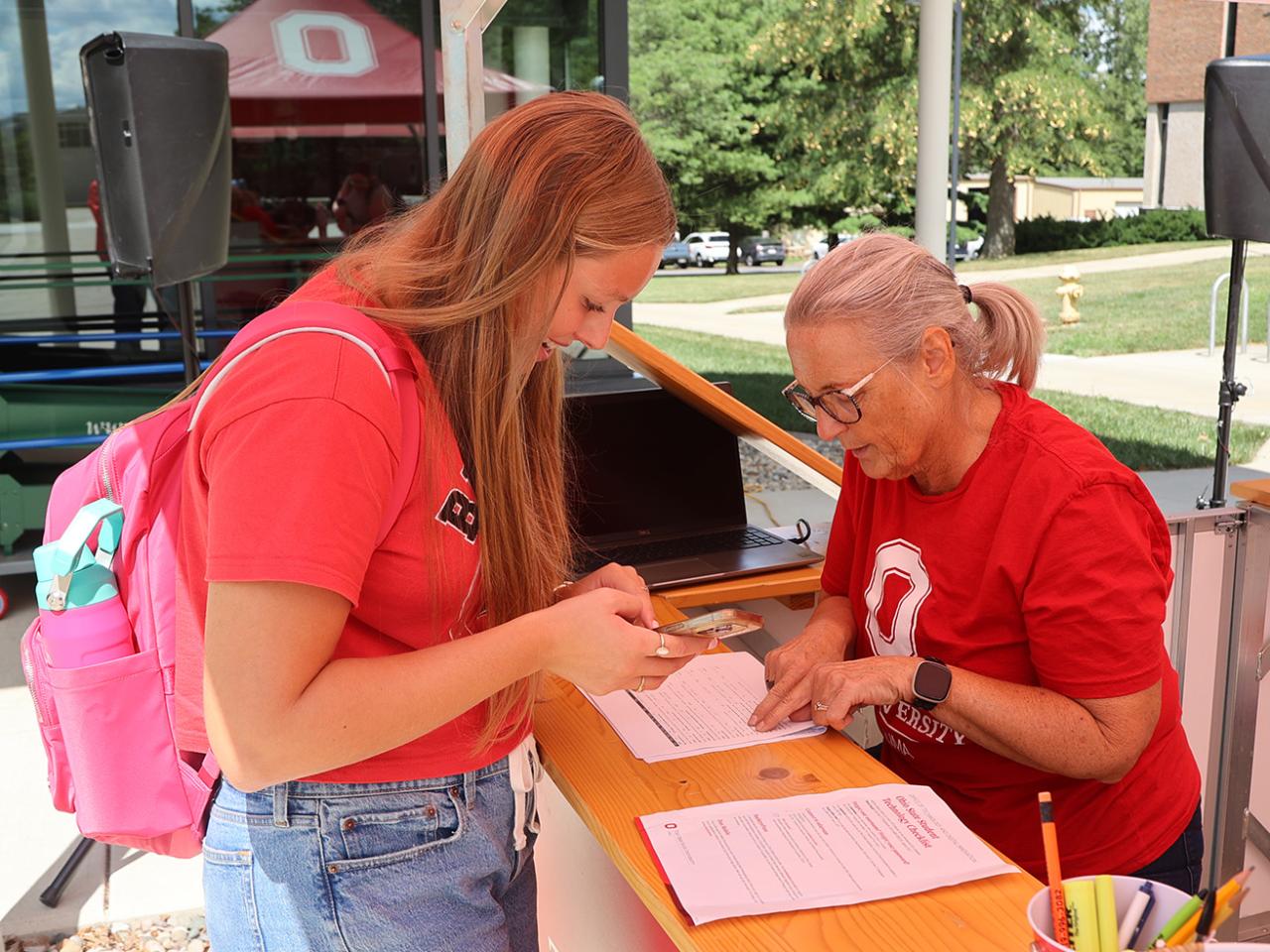 A student and staff member at the Welcome Tent
