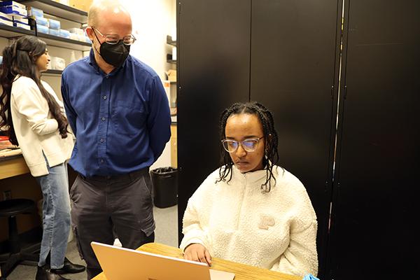 Dr. Ryan Norris and student Leah Beraki in the lab