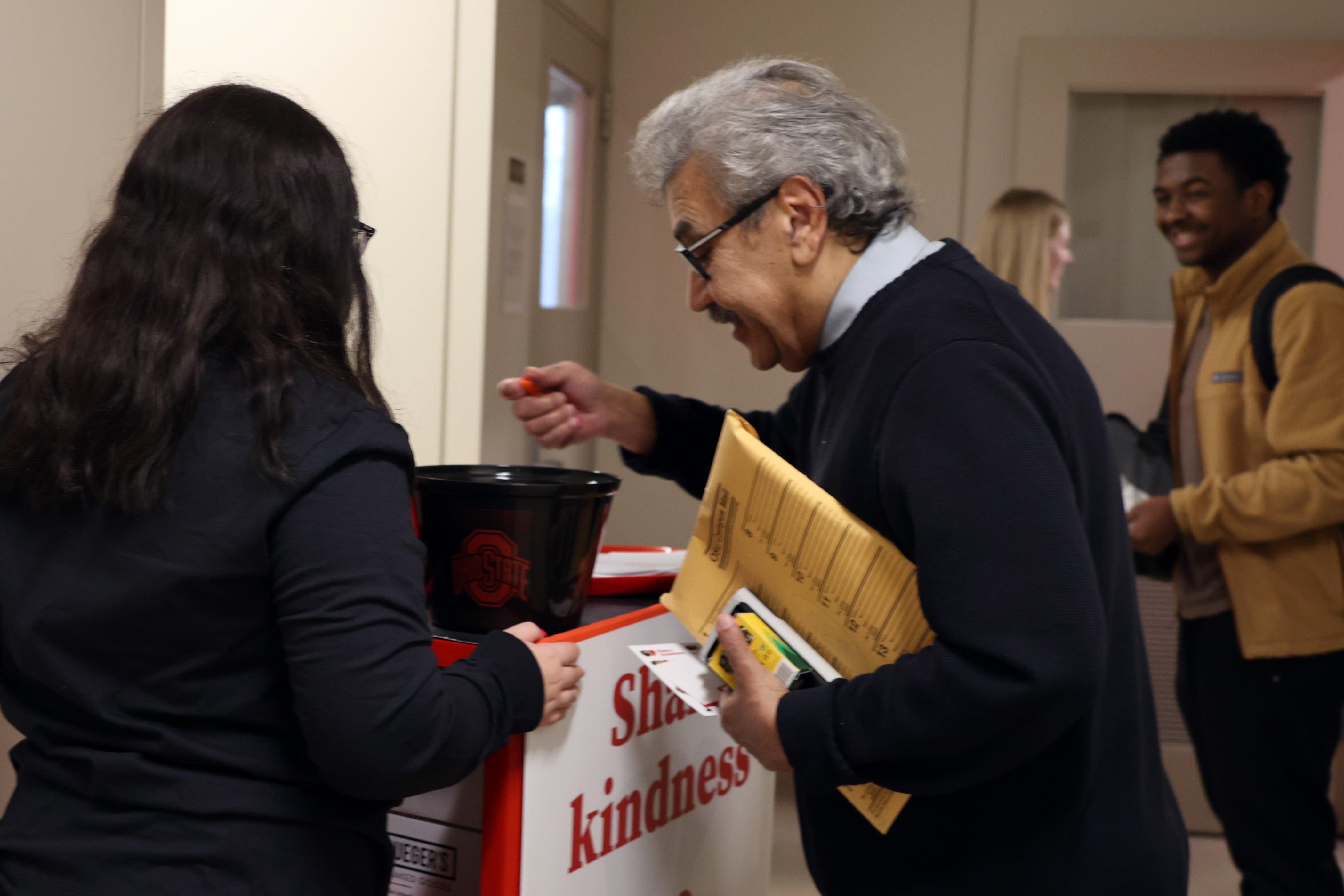 A professor picks out a Share Kindness snack