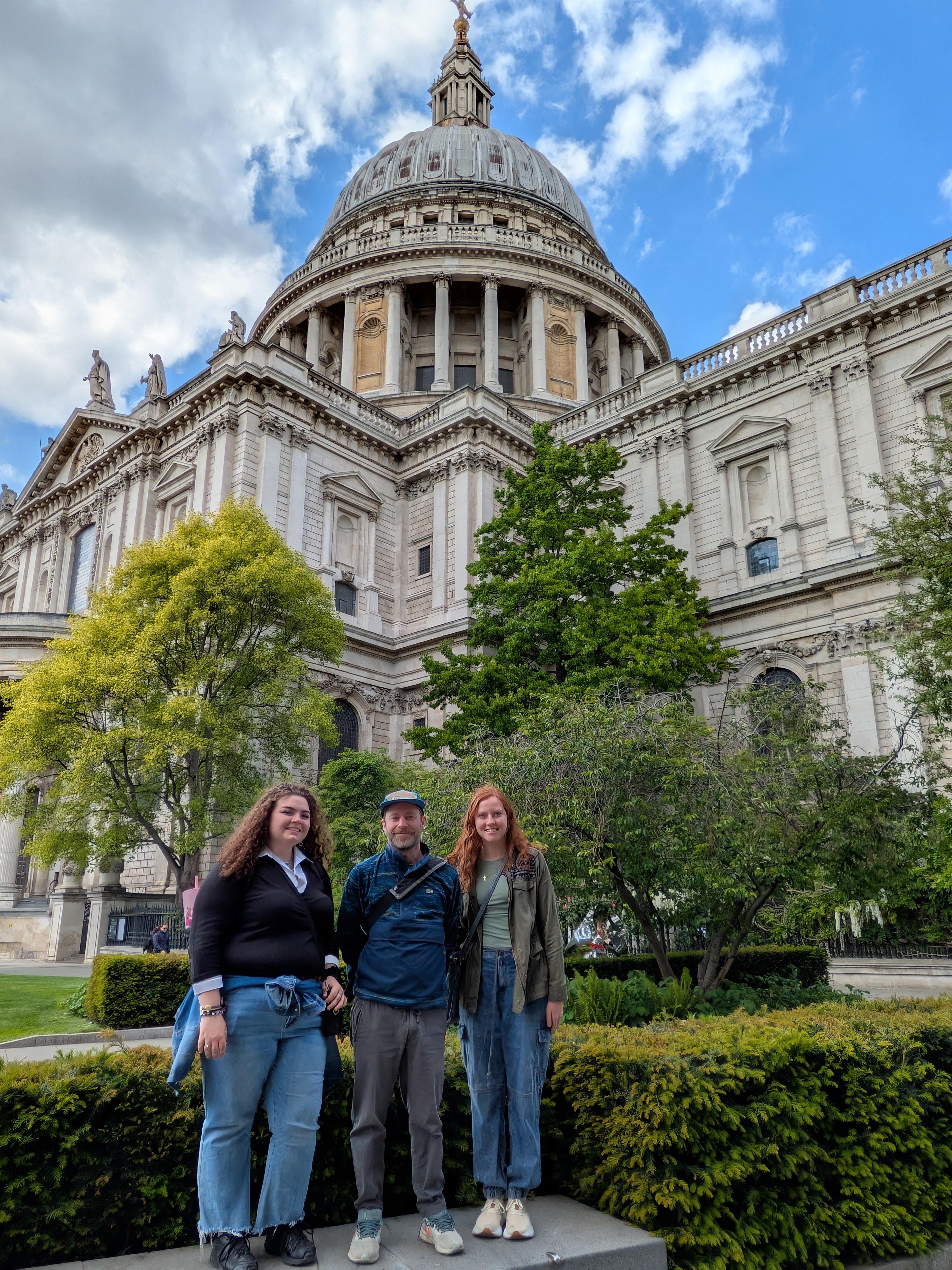 Three people on a study tour at St. Paul's Cathedral in England