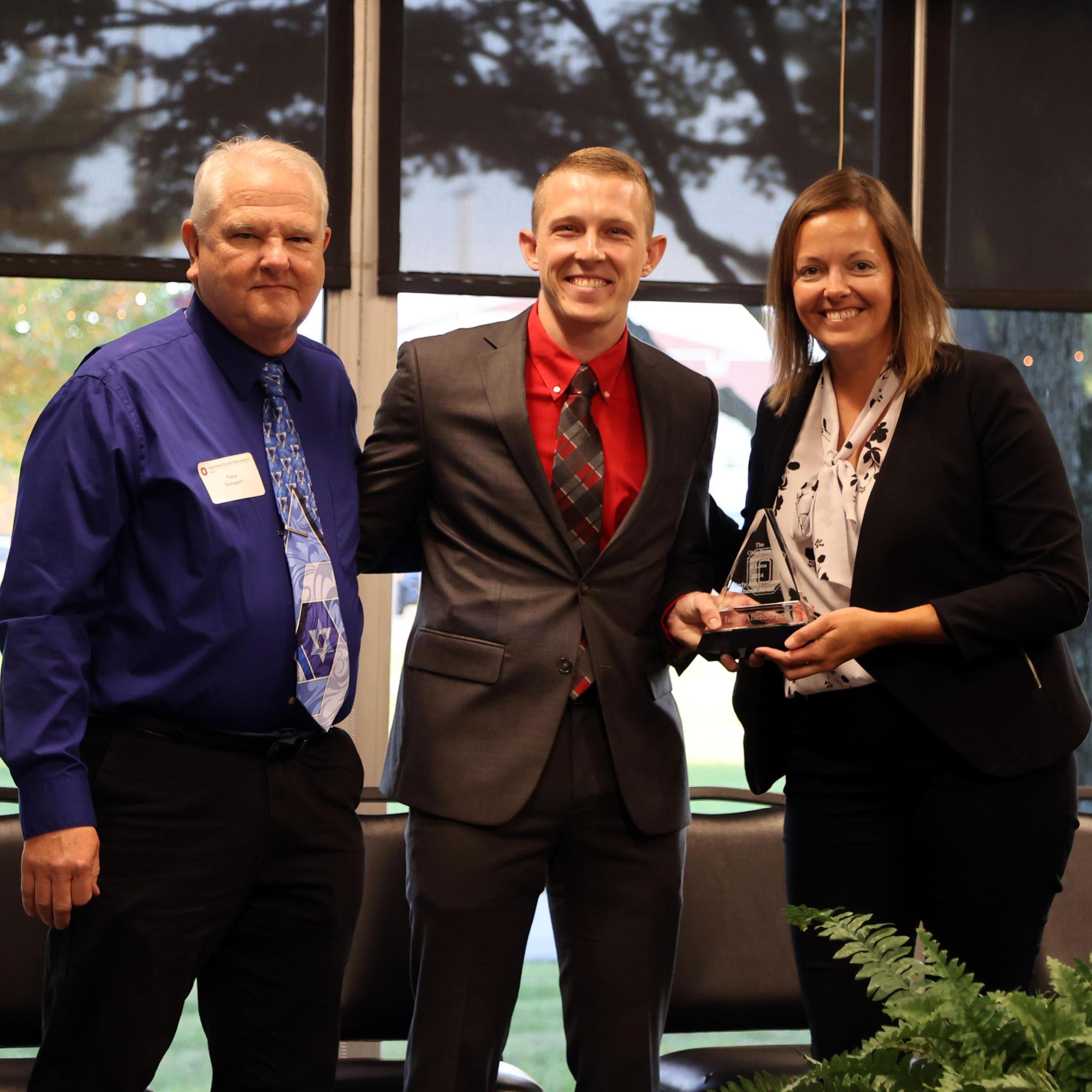 Isaac Altenburger with his Early Achievment Award, nominator Tony Swygart and Dean Meggie Young