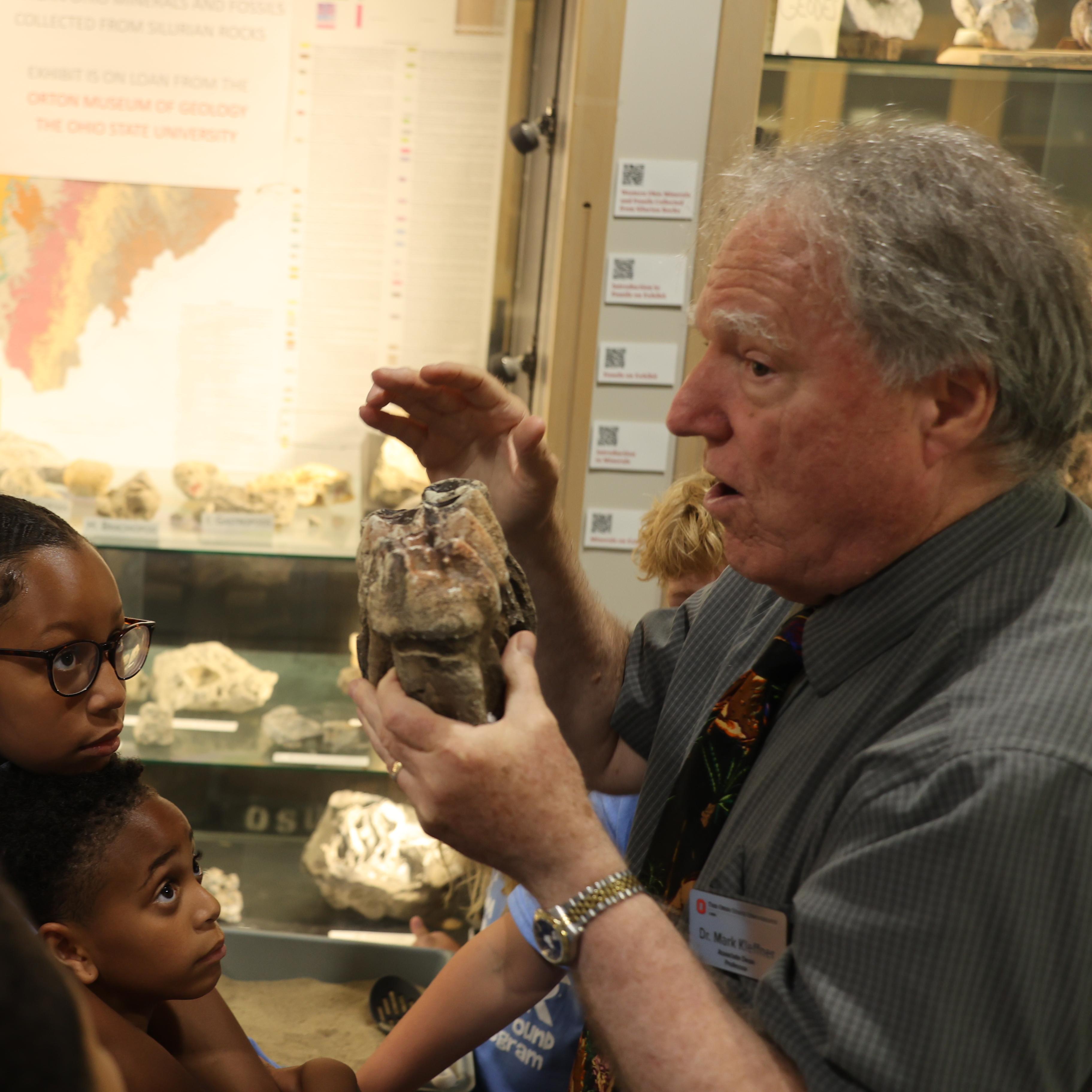 Dr. Mark Kleffner displays a fossil for elementary students to see.