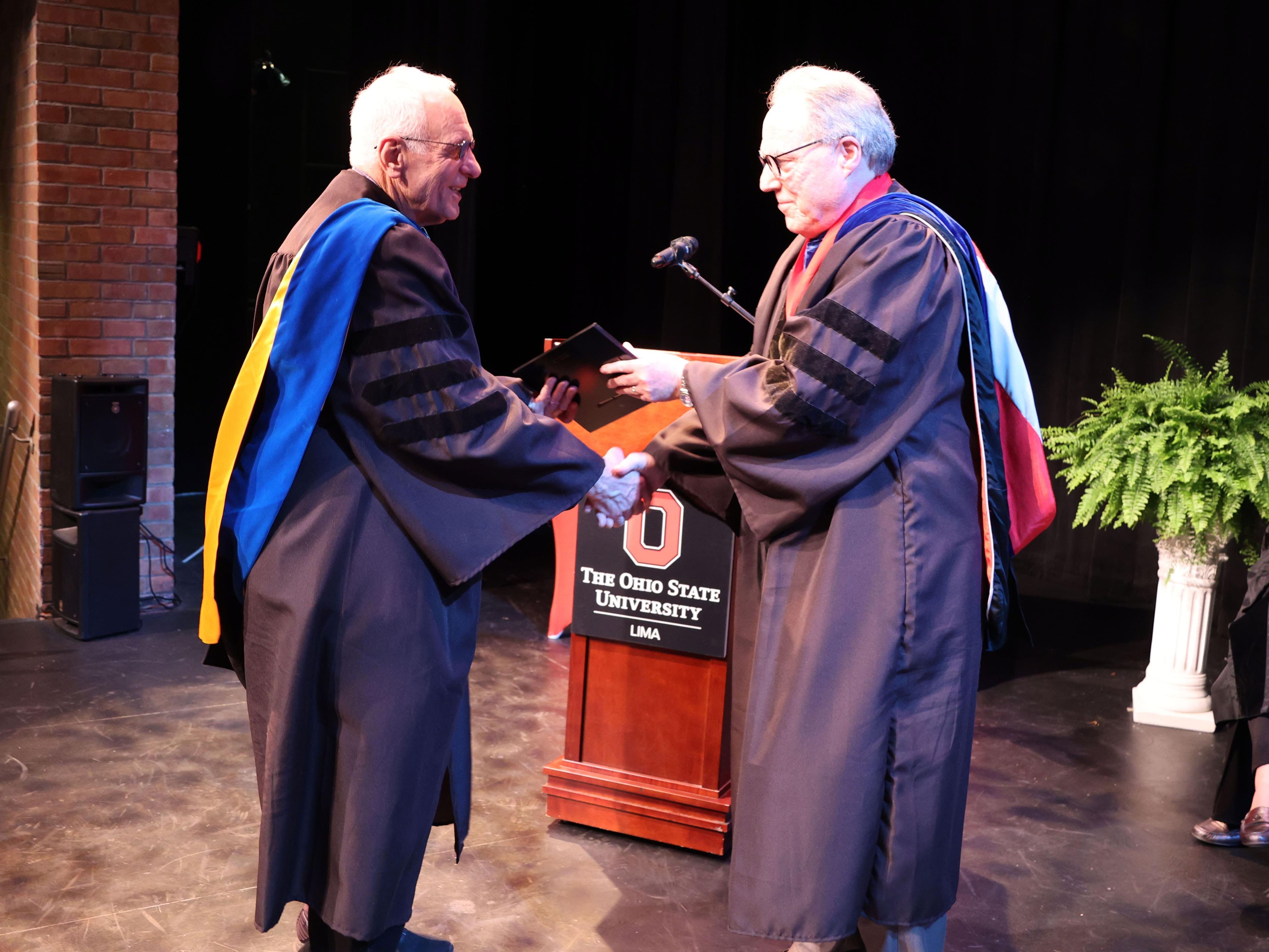 John Hellmann (left) receives the 2024 Teaching Excellence Award