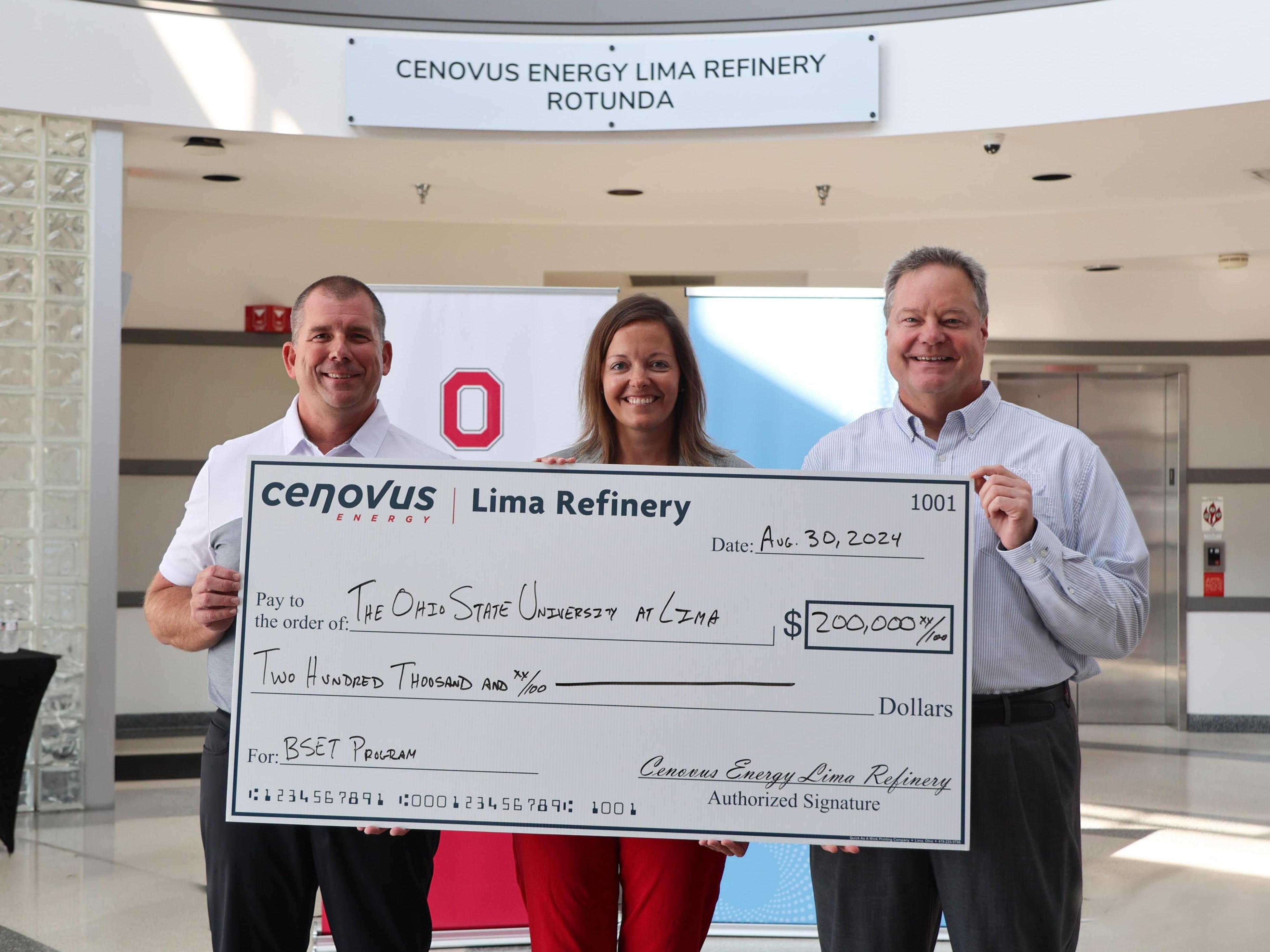 Three people hold a check in Ohio State Lima's Cenovus Energy Lima Refinery Rotunda