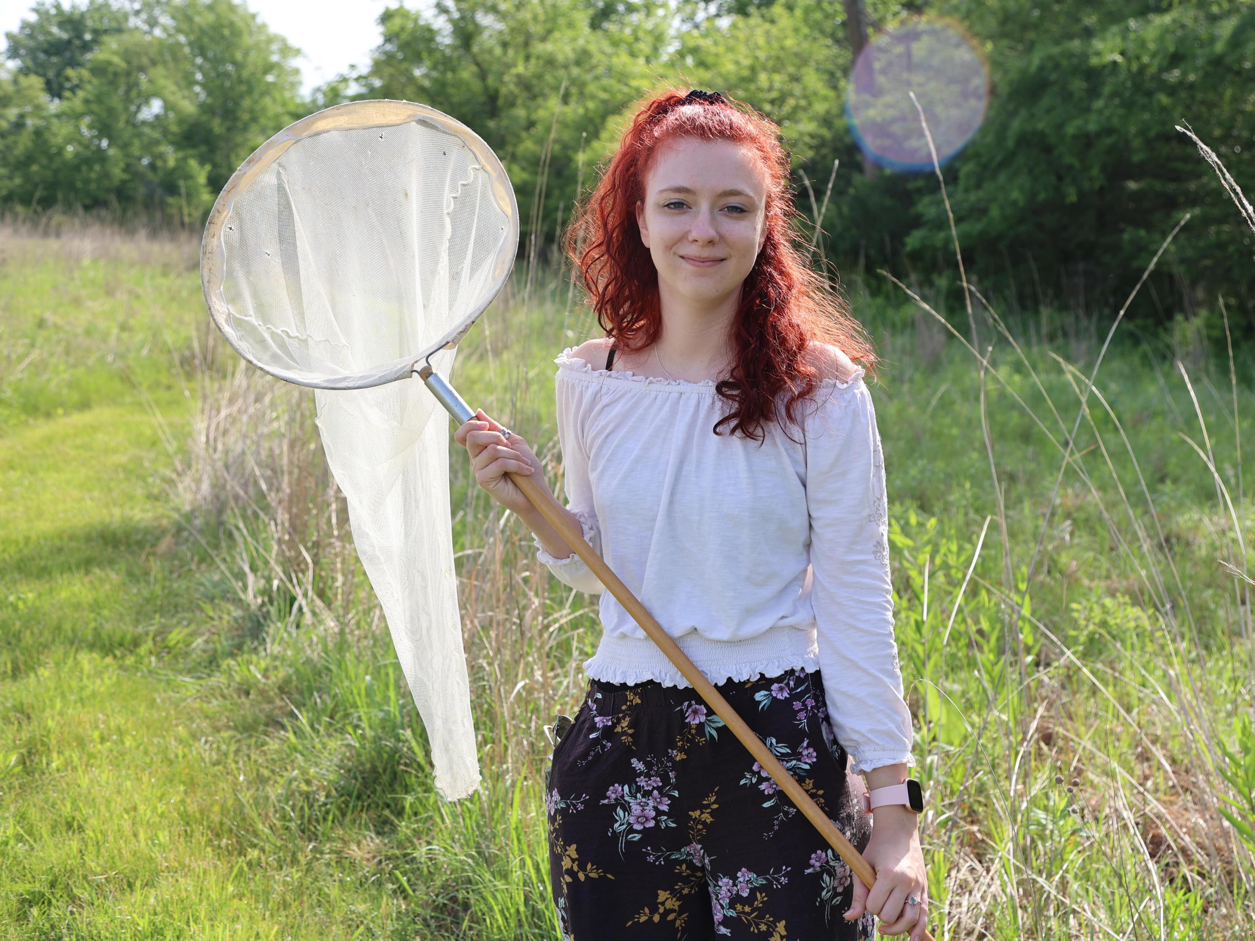 A student with an insect net at Ohio State Lima's prairie