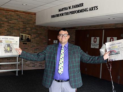 Alumnus Alec Keller holds issues of the Kenton times