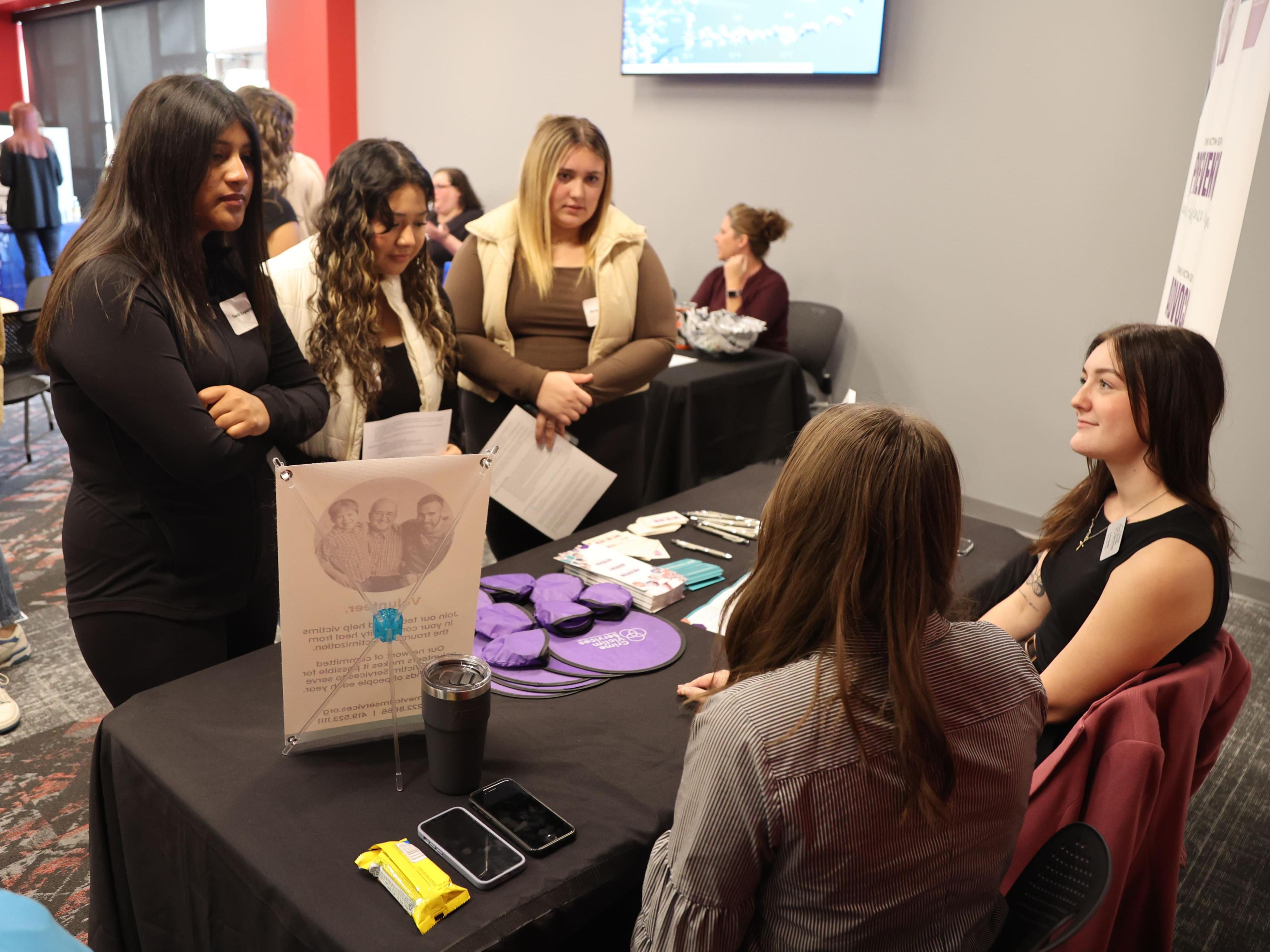 Three high school students talk to two social workers at Ohio State Lima