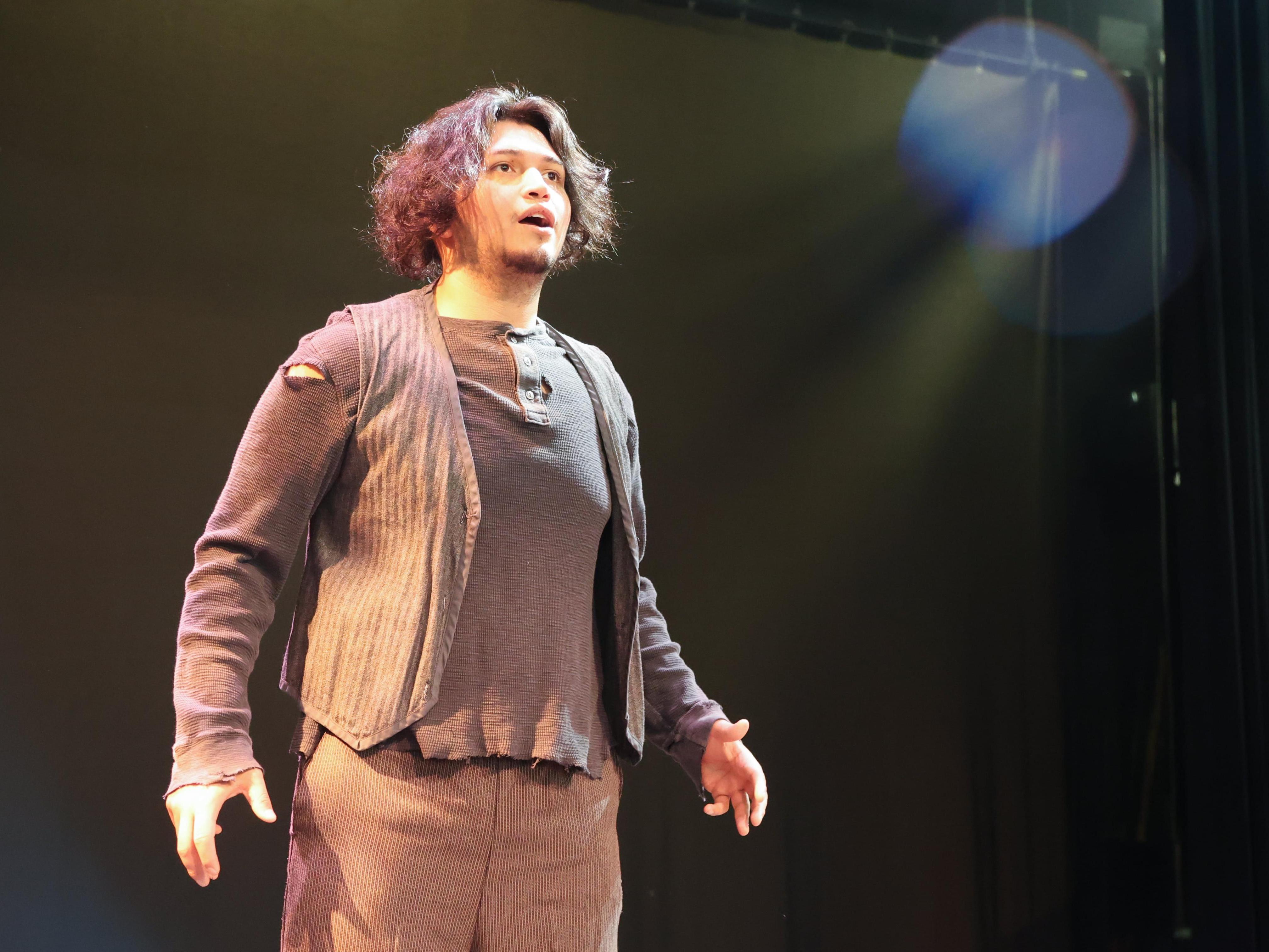 Jose Jones stands on the stage in the Martha W. Farmer Theatre for the Performing Arts