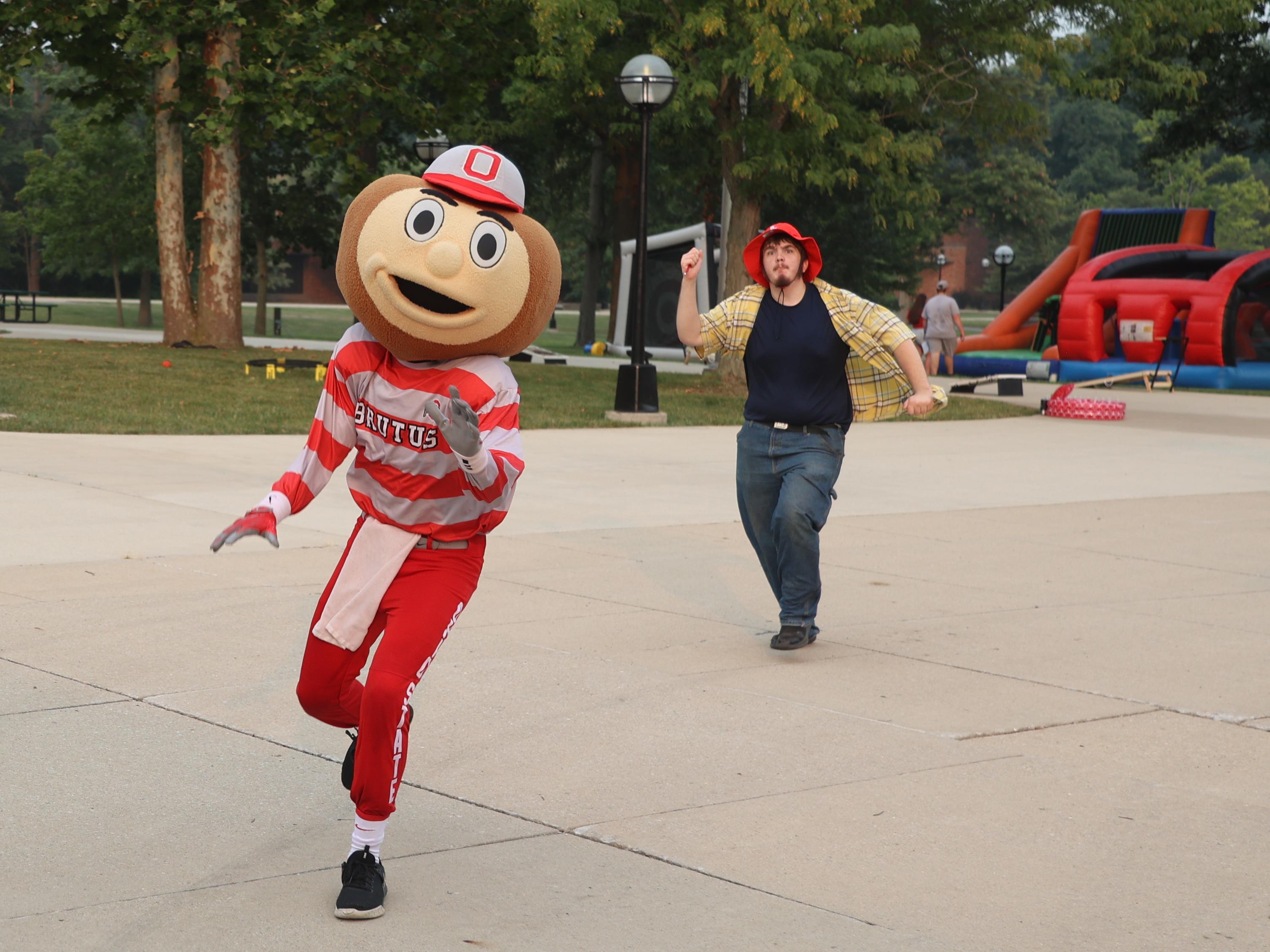 Brutus Buckeye runs toward the camera. 