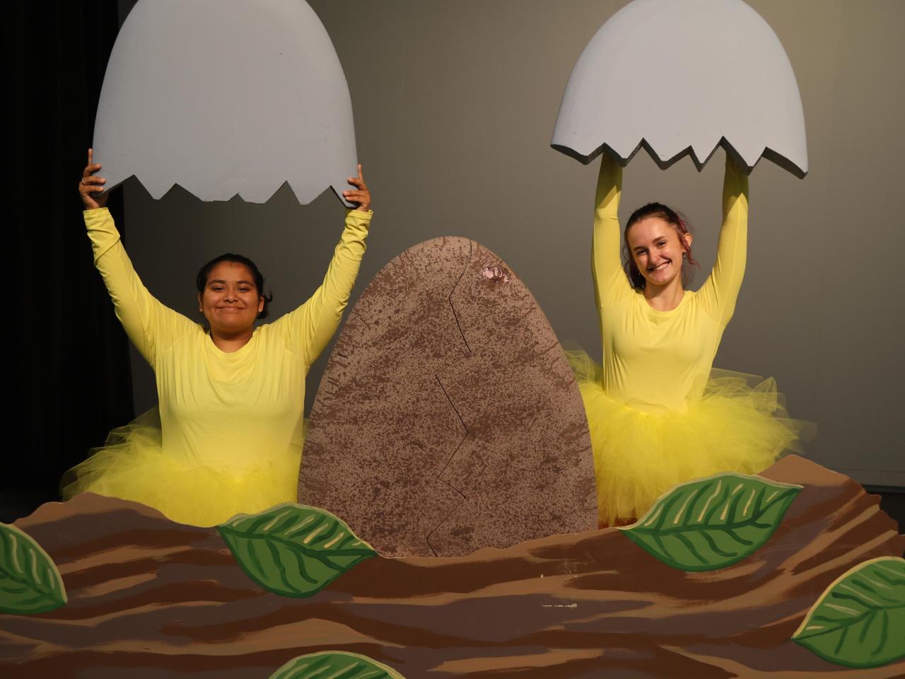 Two ducklings emerge from their eggs on stage