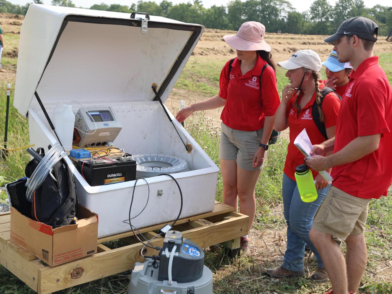 Ohio State students examine the all-weather water monitoring system