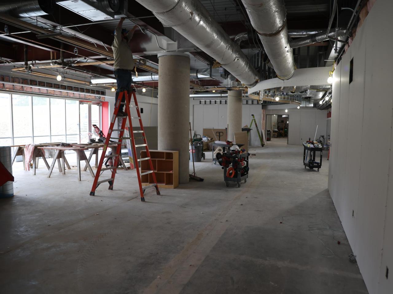 worker on ladder working on ceiling in galvin basement 2023-03-23-1