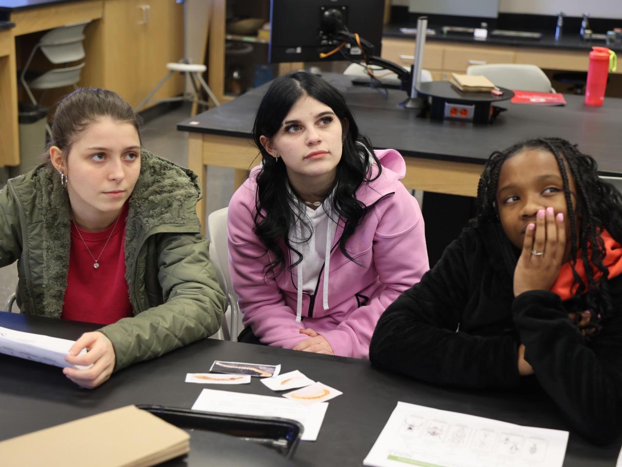 Three students in a science lab