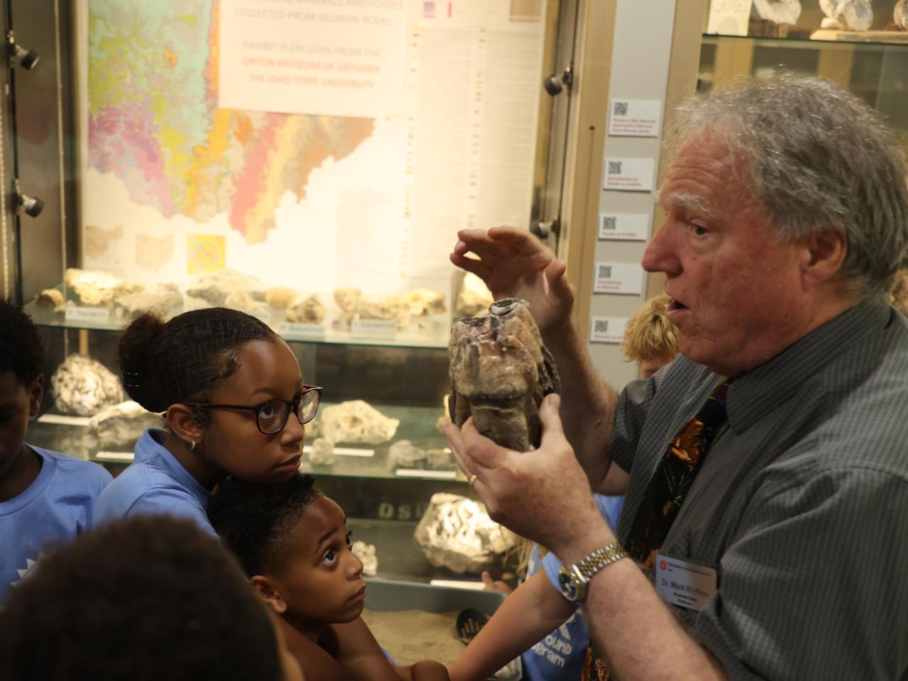 Dr. Mark Kleffner displays a fossil for elementary students to see.