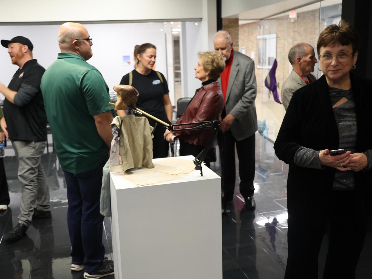 Guests at a theatre celebration talk in the Farmer Family Gallery