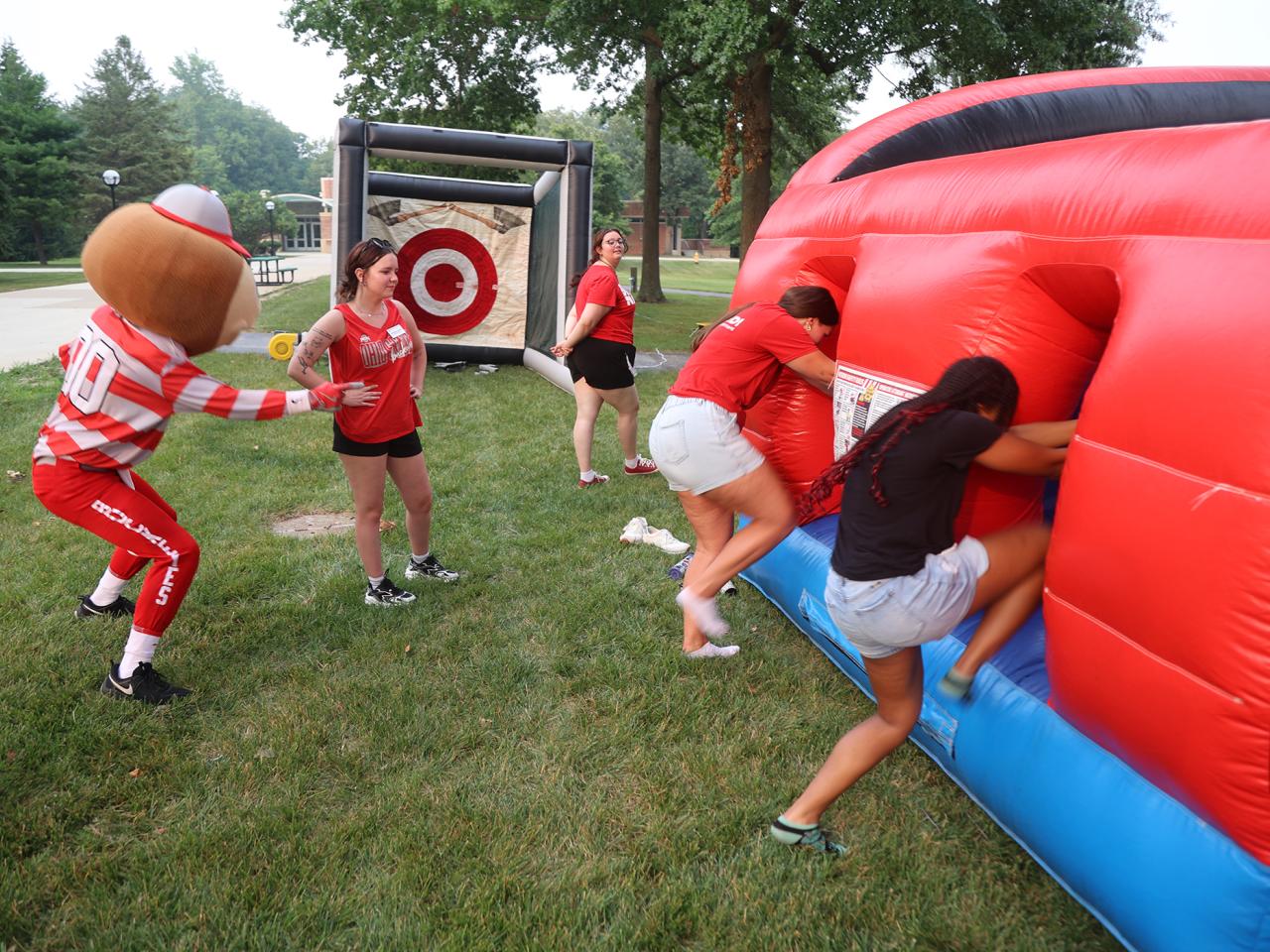 Brutus Buckeye starts a race into an inflatable obstacle course.