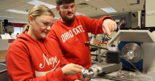 Engineering students working on a metal lathe