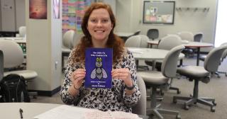 Author Nicole Pohlman holds her first book in the Learning Center