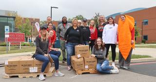 Group of students and staff with food boxes
