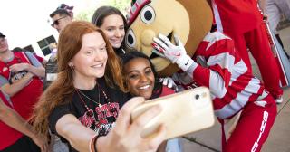 Students take a selfie with Brutus Buckeye