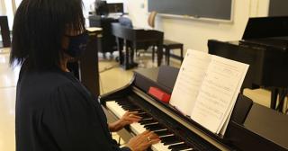Temple Patton plays one of the pianos in the temporary piano lab in Reed Hall.