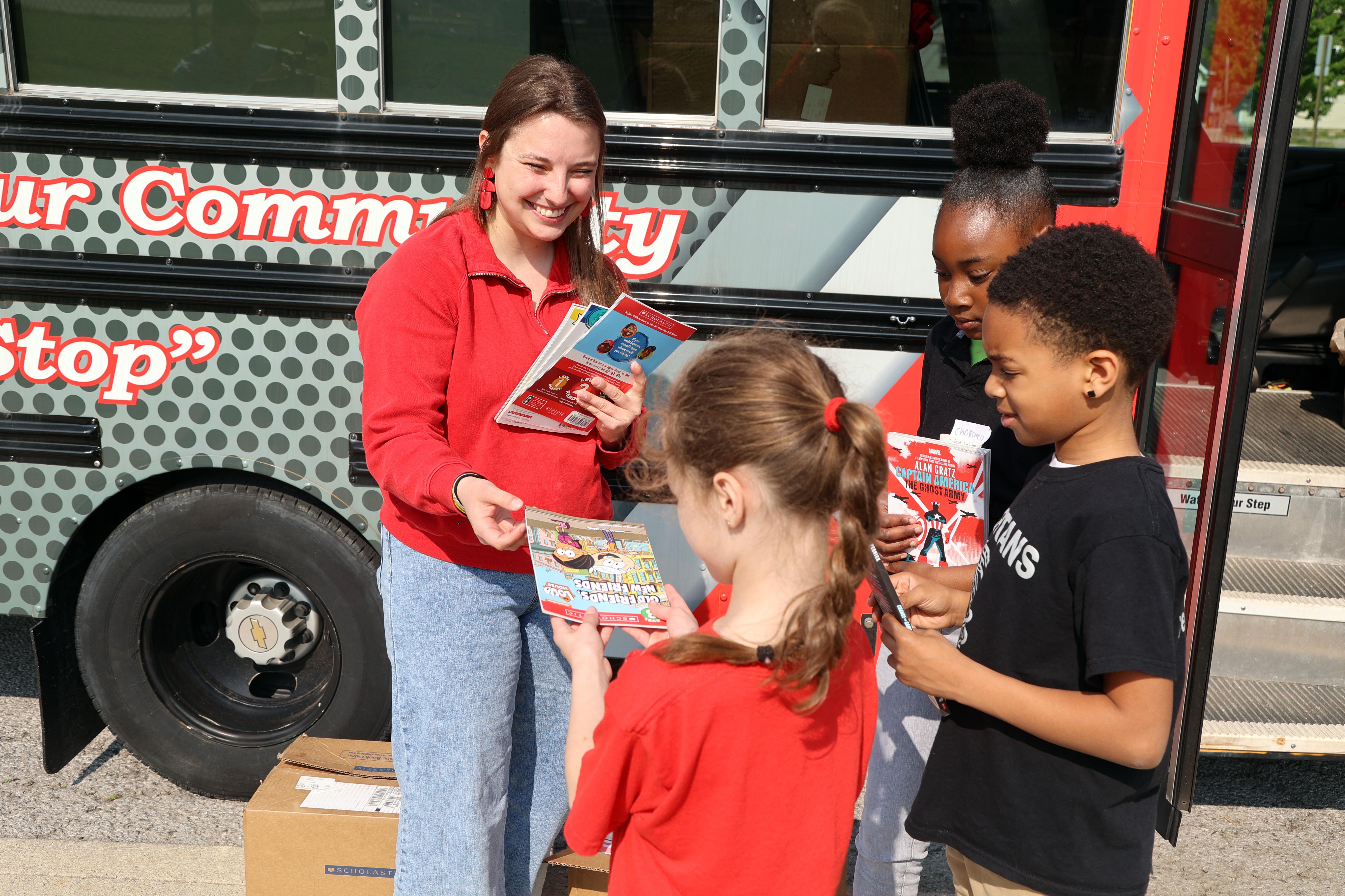 Education Club President Brianne Ballenger delivers books to the Spartan Ride