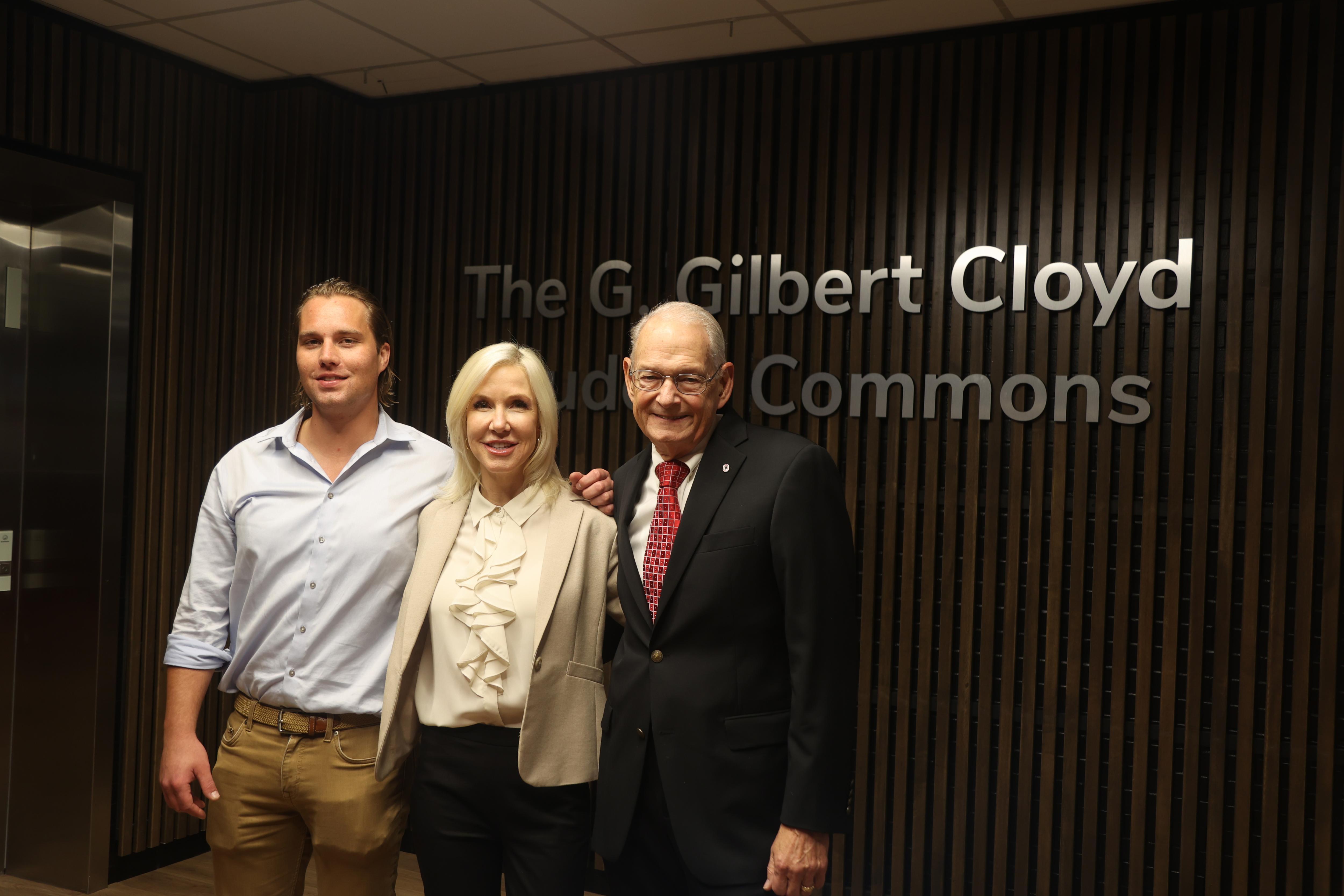 Will Navin, Lisa Navin and Gil Cloyd in front of the G. Gilbert Cloyd Student Commons sign