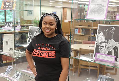 Lauren Chatman-Wright in front of her research display in the library