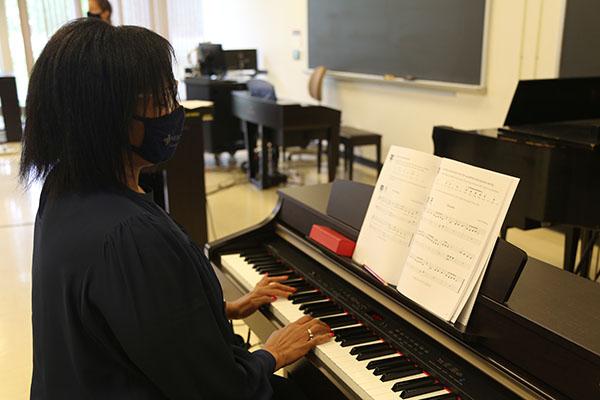 Temple Patton plays one of the pianos in the temporary piano lab in Reed Hall.