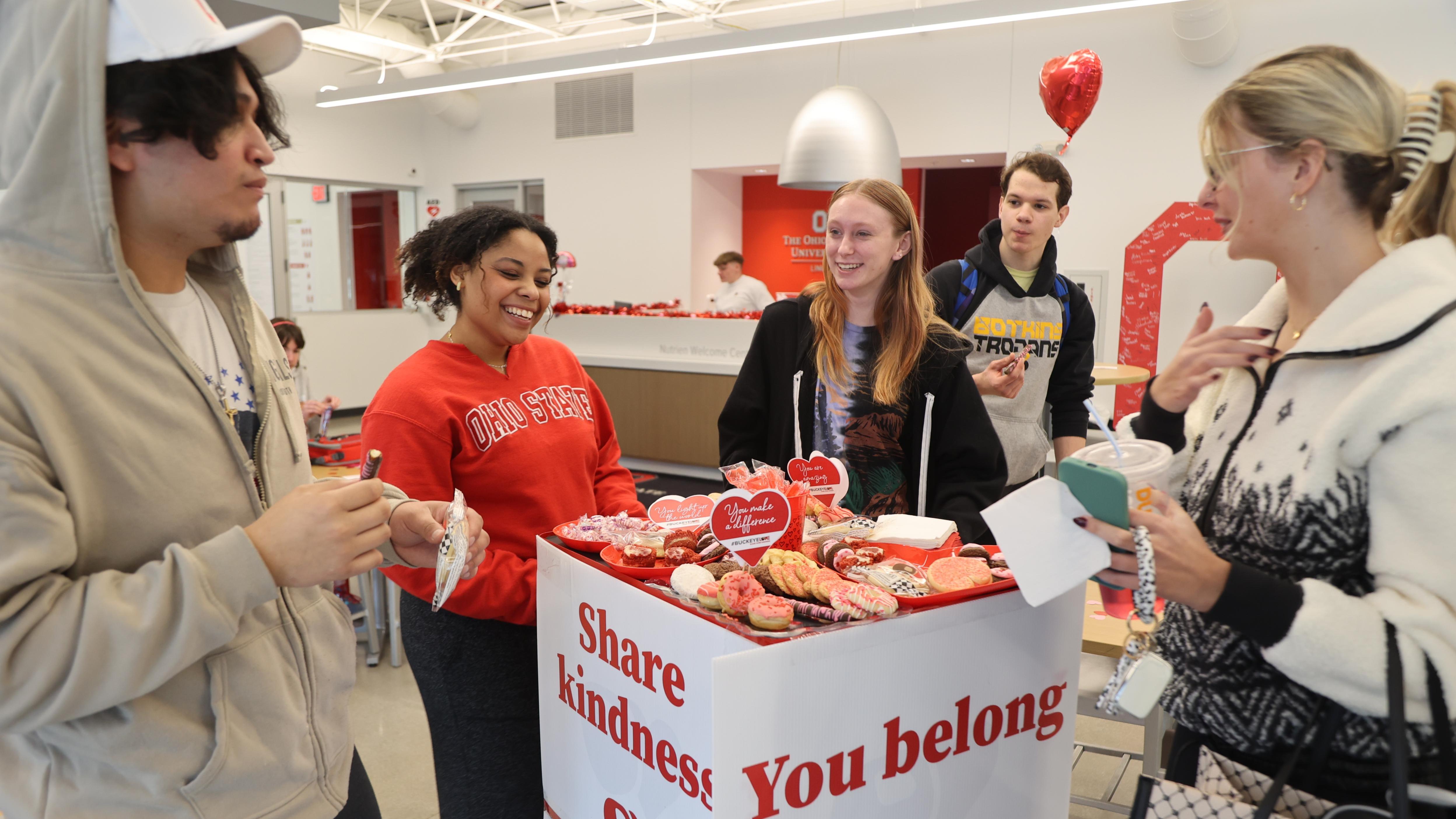 Students pass out Buckeye Love treats in the Webb