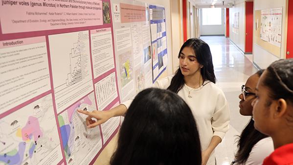 Students look at a research poster