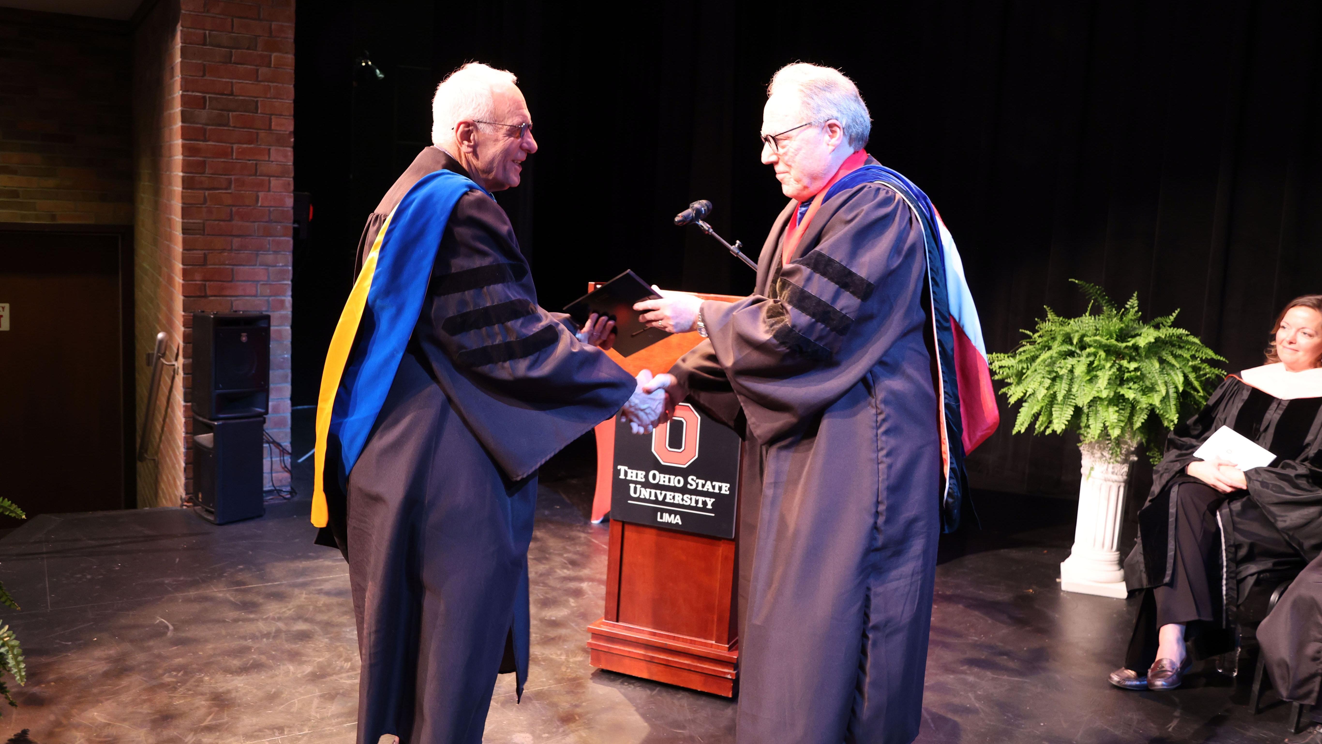 John Hellmann (left) receives the 2024 Teaching Excellence Award