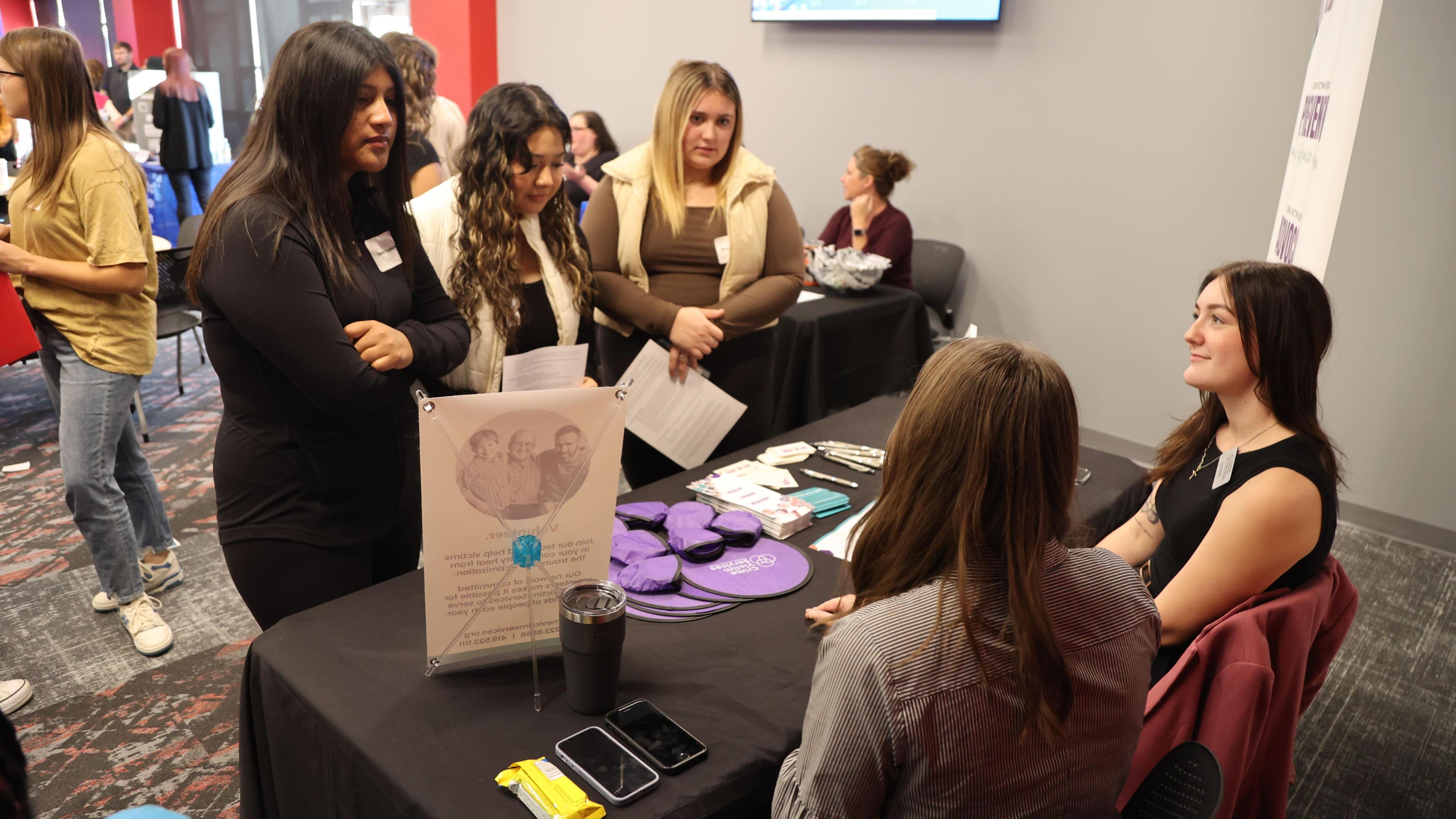 Three high school students talk to two social workers at Ohio State Lima