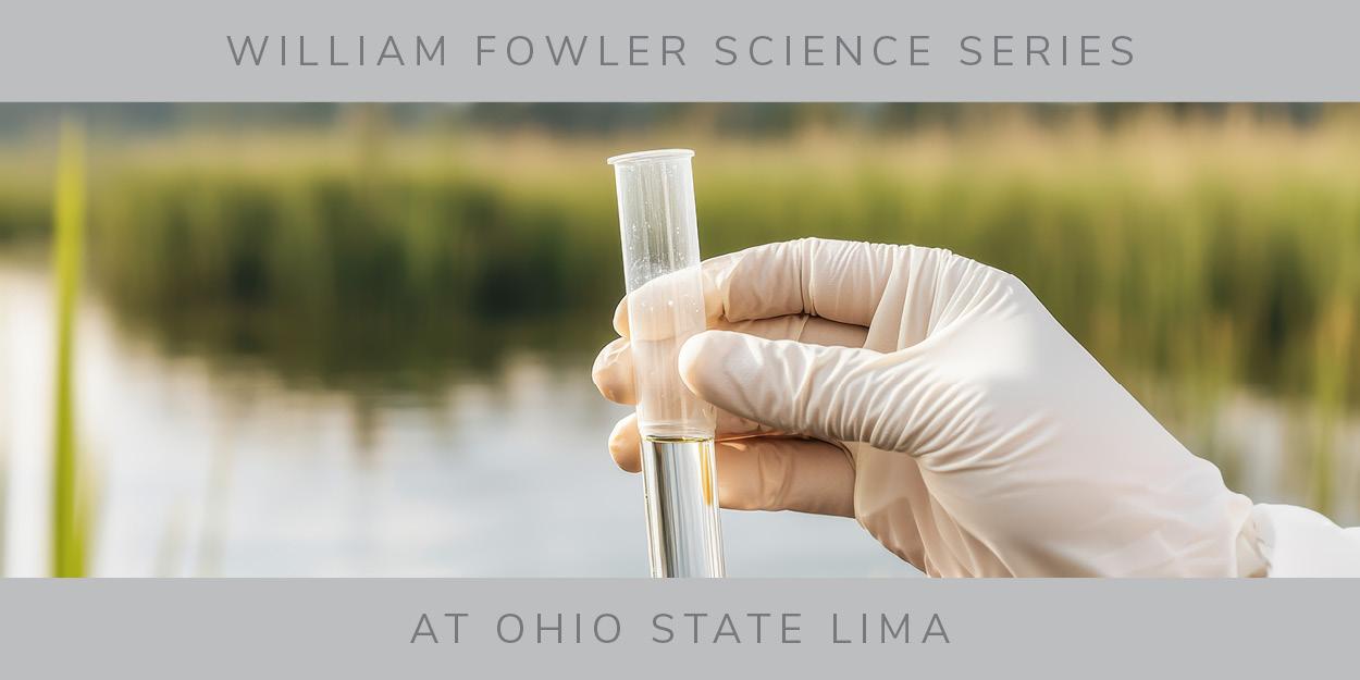 Gloved hand holding a test tube in front of blurred creek bed