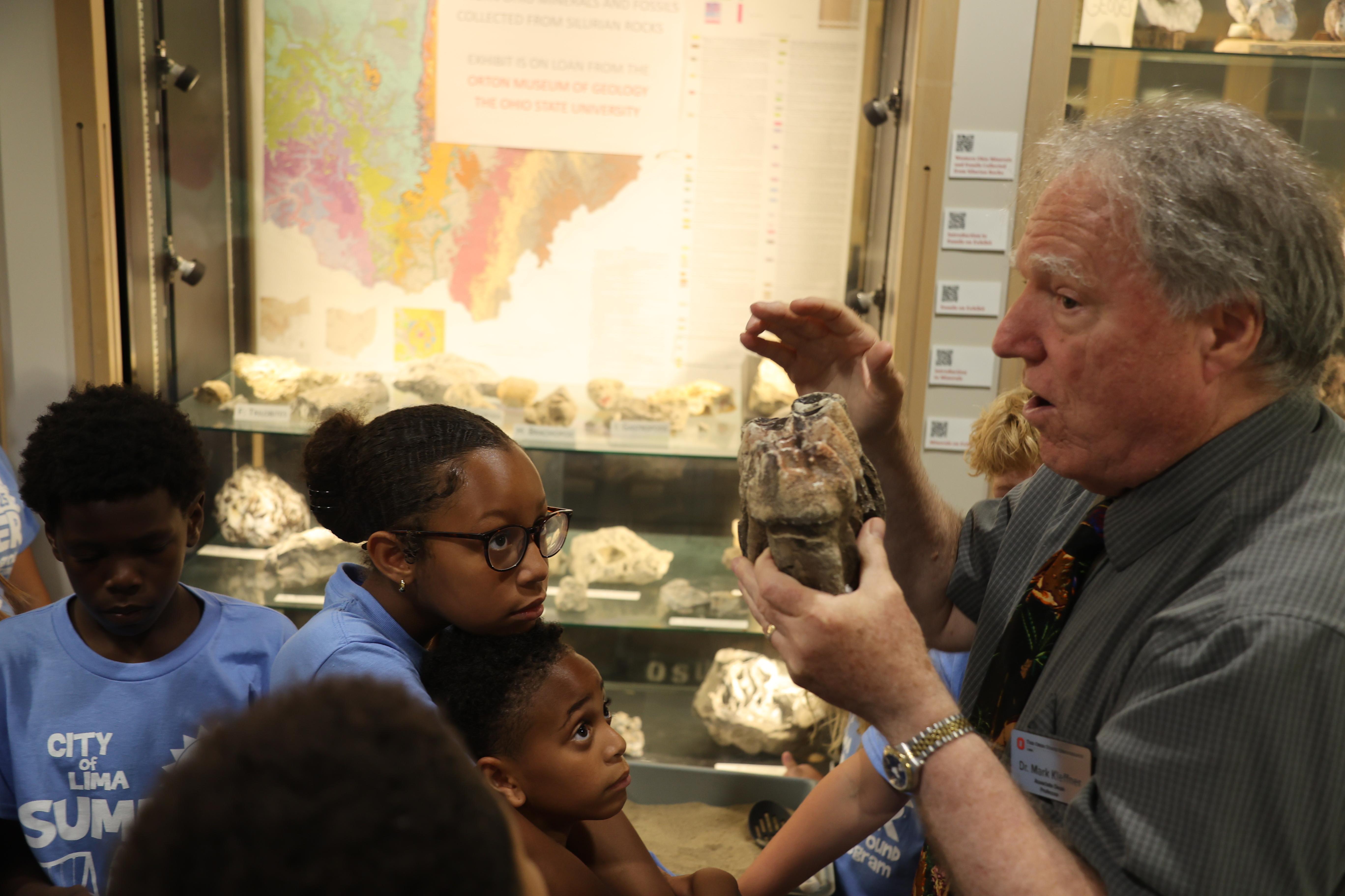 Dr. Mark Kleffner displays a fossil for elementary students to see.