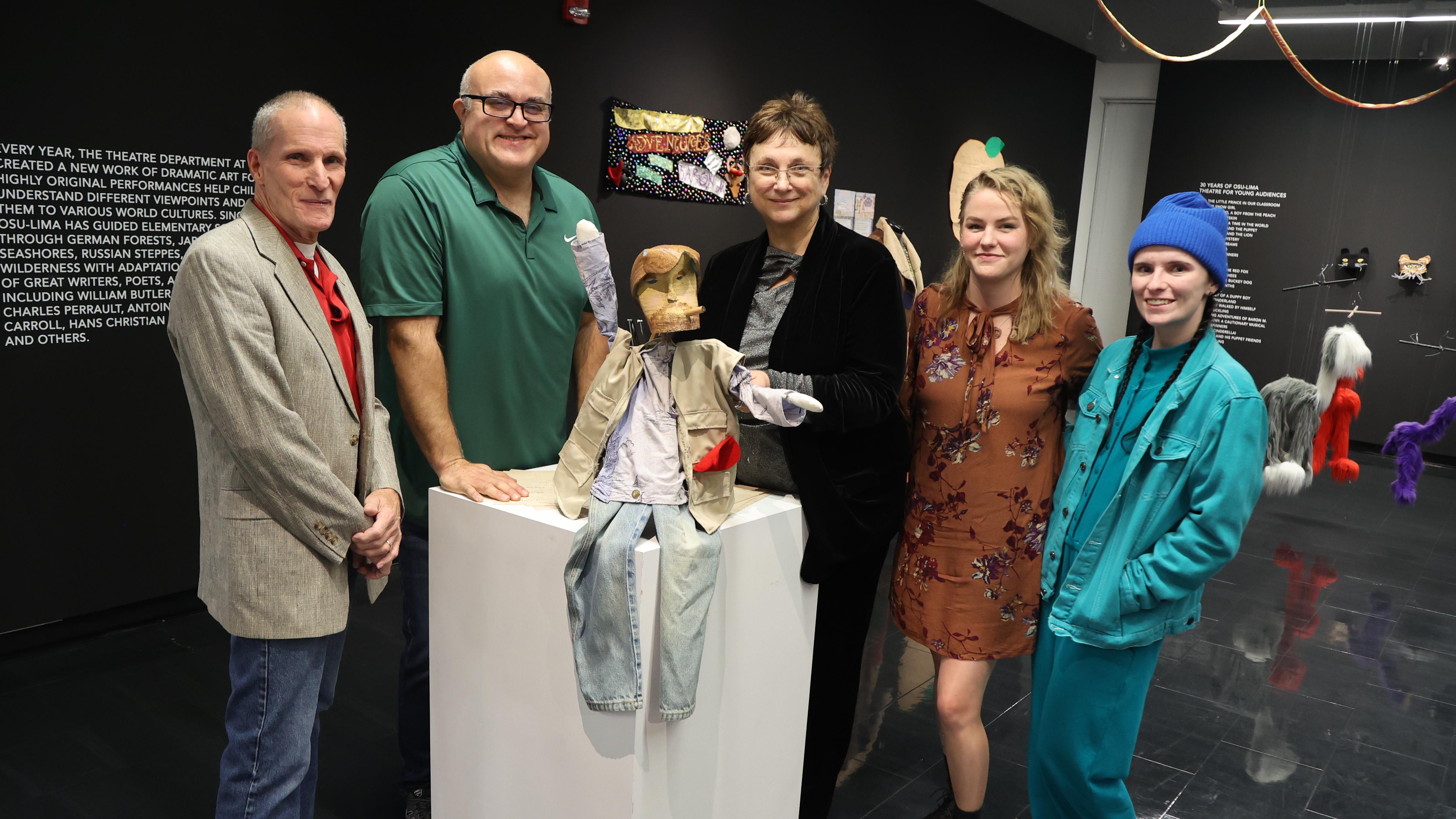 Theatre alumni with a professor in the Farmer Family Gallery