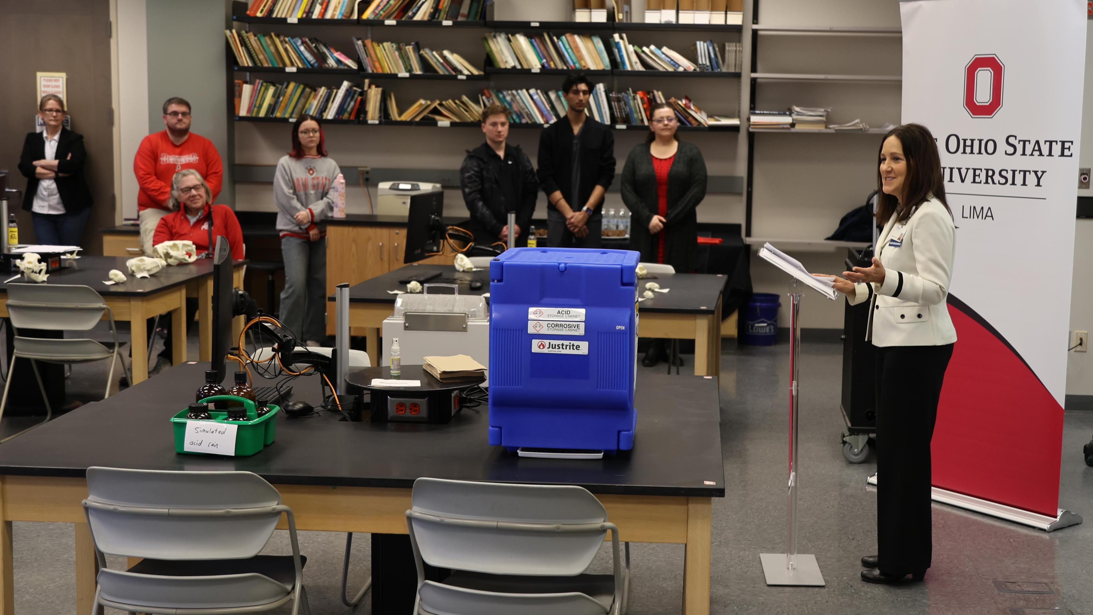 Mercy Health's Ronda K. Lehman speaks to a group in a biology lab. 