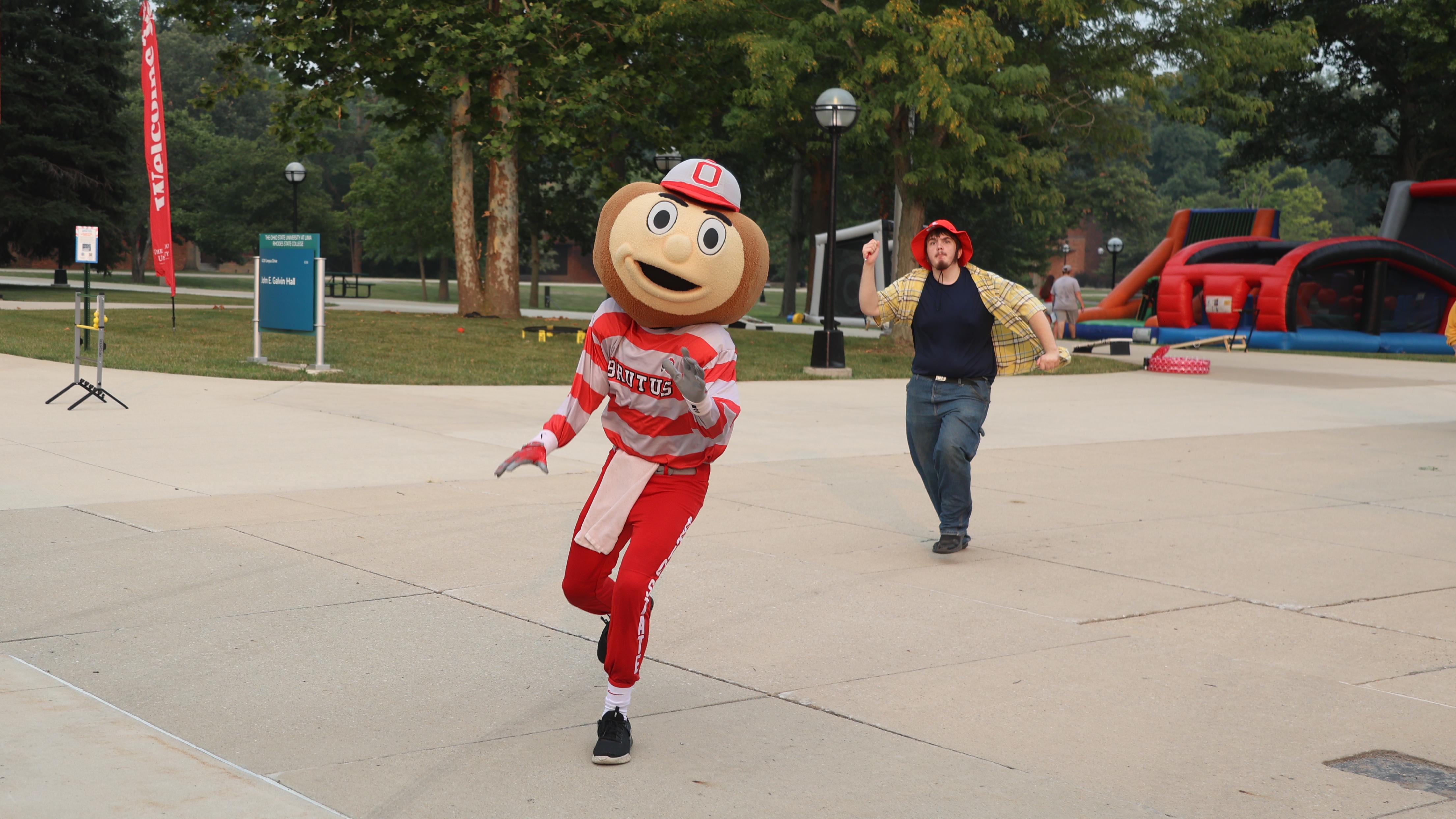 Brutus Buckeye runs toward the camera. 