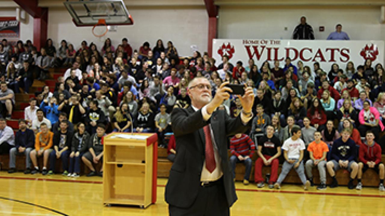Provost taking a selfie with a large group of students