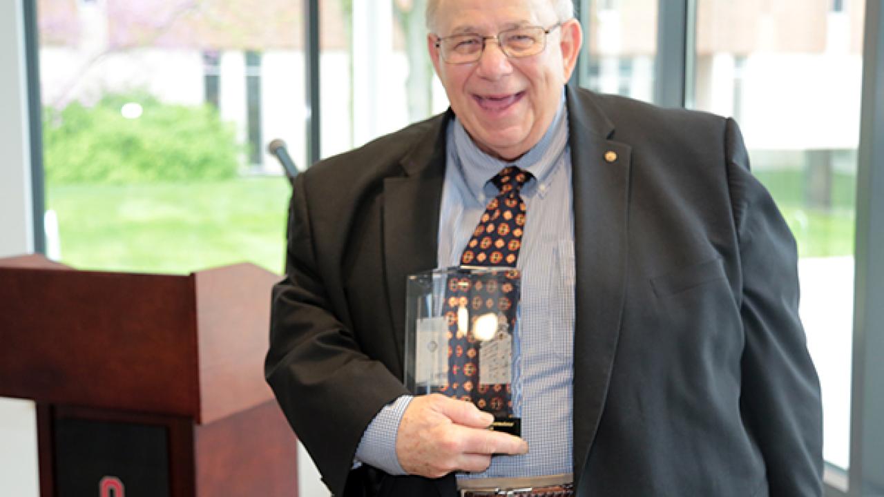 Bill Timmermeister holding an award