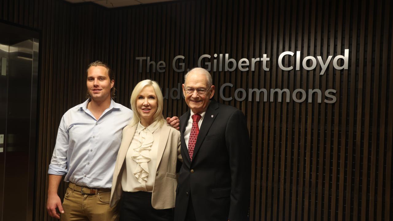 Will Navin, Lisa Navin and Gil Cloyd in front of the G. Gilbert Cloyd Student Commons sign