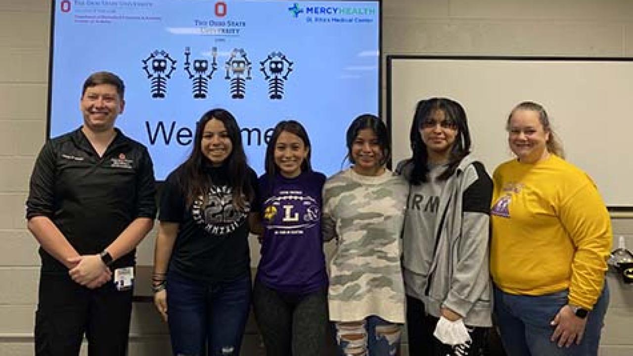 students in front of a screen with OHIO spelled in skeletons